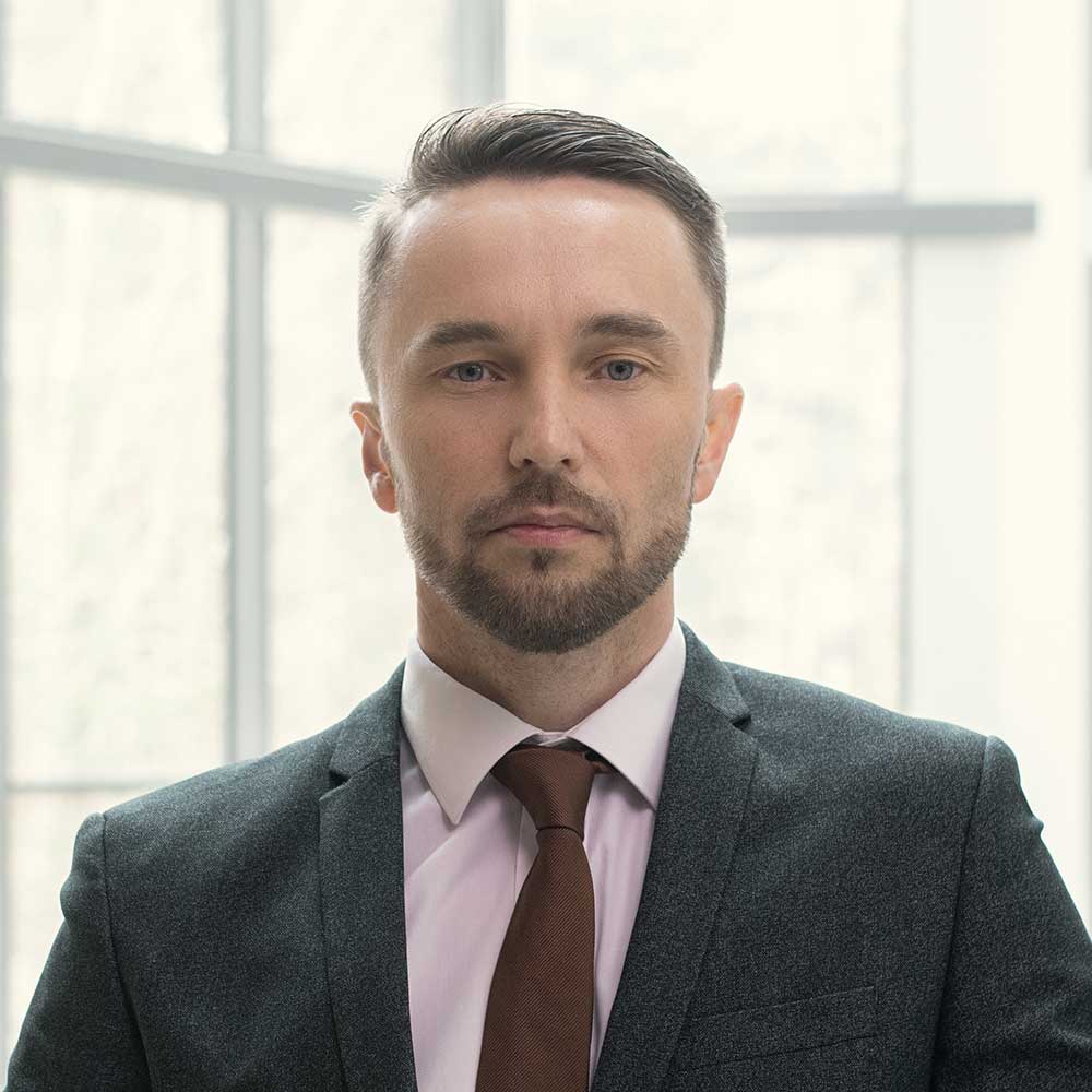 businessman-standing-at-office-RULJWSZ