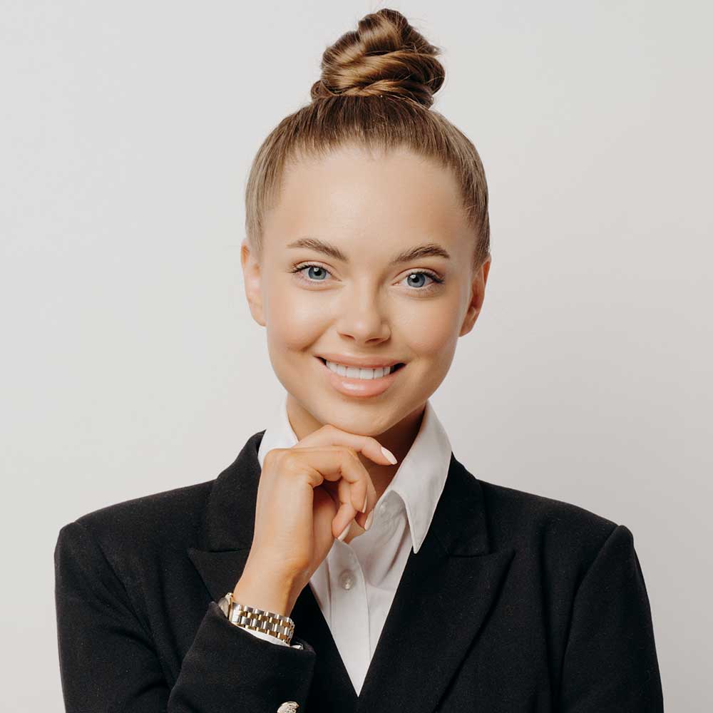 happy-female-office-worker-with-hand-on-chin-RRP5GH2